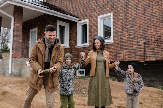 happy family in front of their new home